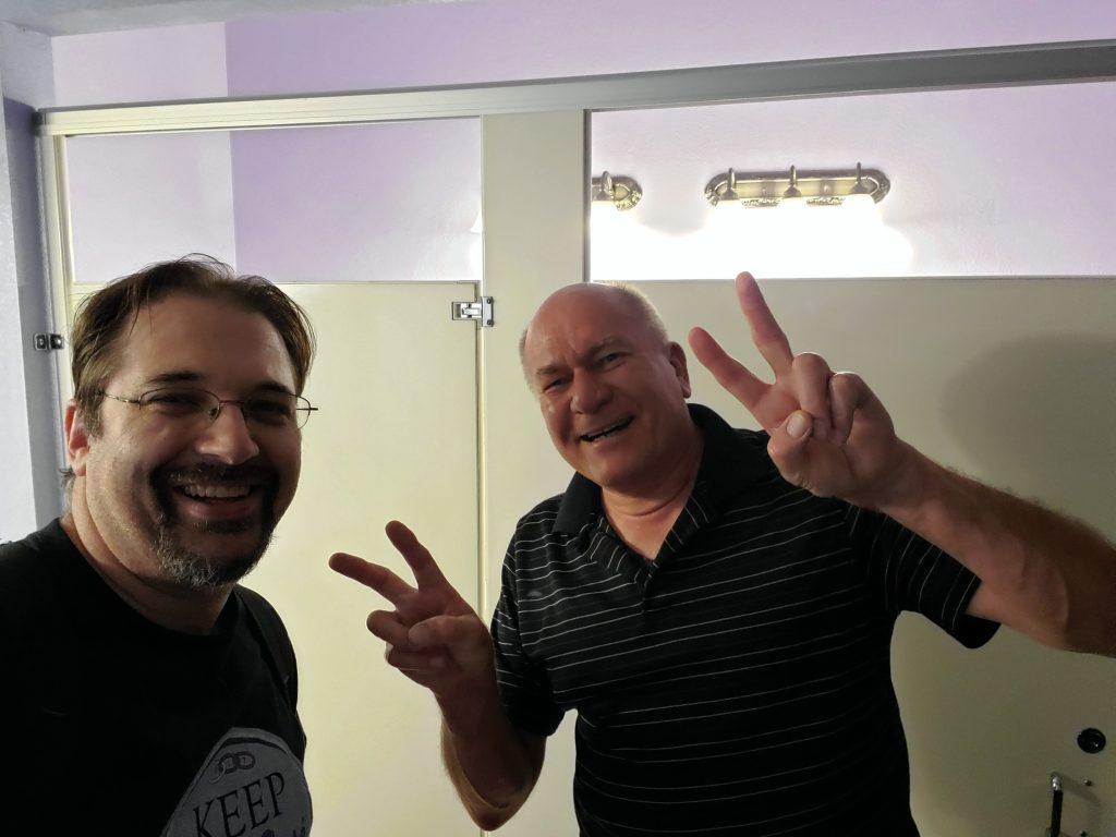 Greg Gentile flashes a victory sign after fixing a toilet