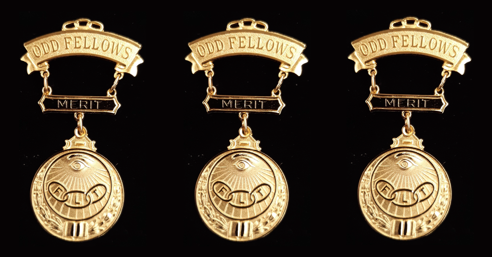 Three badges of merit on a black background